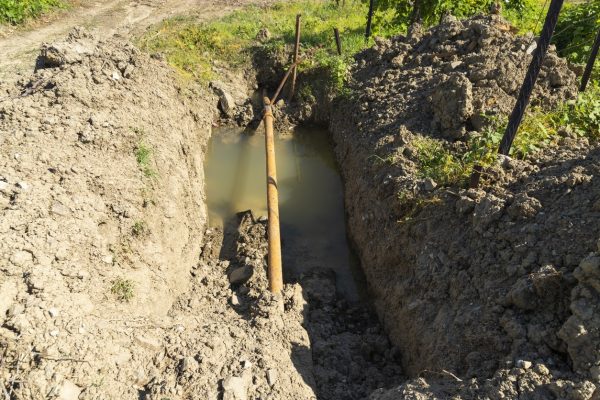 rusty metal pipes in a pit