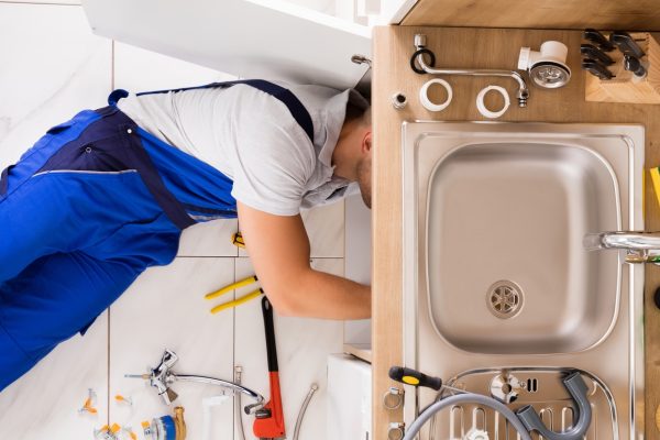 Plumber Fixing Sink